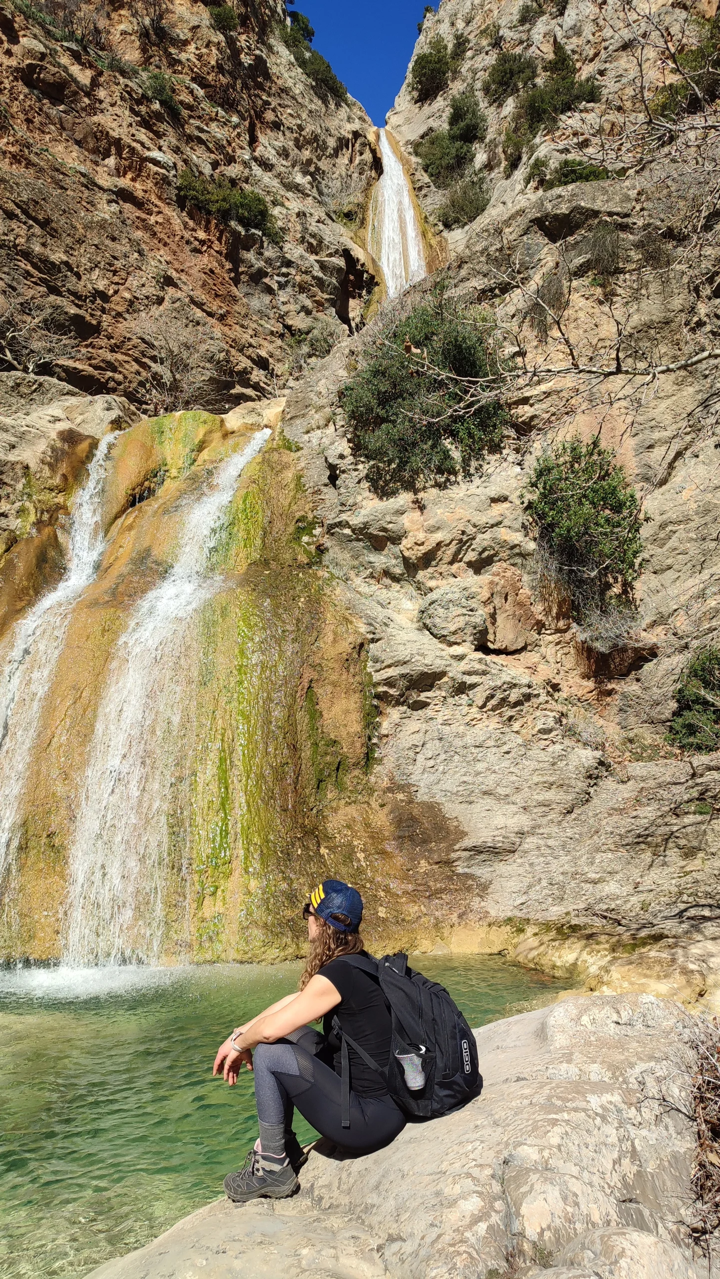 a hiker staring at the waterfall