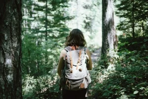 a woman hiking in the forest